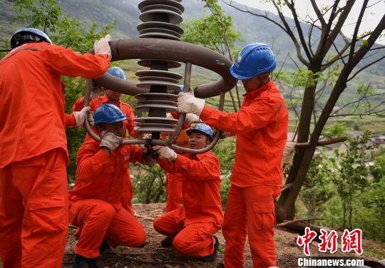 圖為電力工人首次在特高壓復(fù)奉線(xiàn)重慶段開(kāi)展整串絕緣子串更換工作?！≈芤?攝