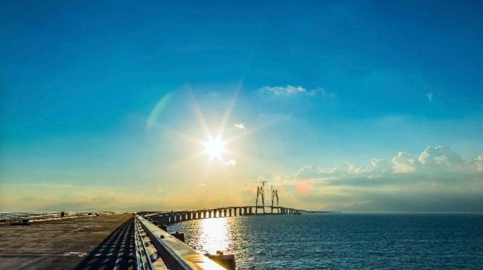 電力史上一次里程碑式工程,港珠澳大橋集橋梁、海底隧道和人工島為一體。為了確保大型船只在世界上最繁忙的黃金水道之一的伶仃洋航道暢通無阻，并避免影響飛機在香港國際機場的安全起降，港珠澳大橋并沒有全部采用橋梁結(jié)構(gòu)，而是在經(jīng)過伶仃洋航道時采用海底沉管隧道，并通過東、西兩座人工島將隧道與海上橋梁相連。